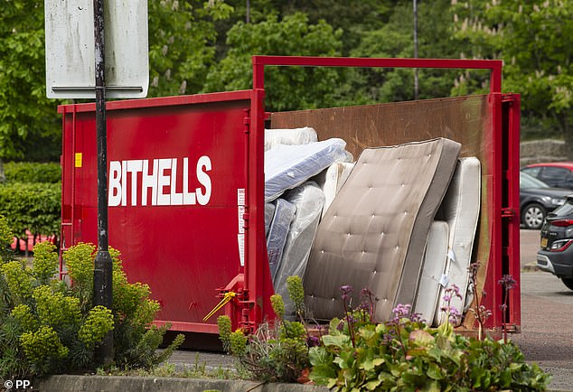 New and old mattresses lie in a metal container outside the Daresbury Park hotel