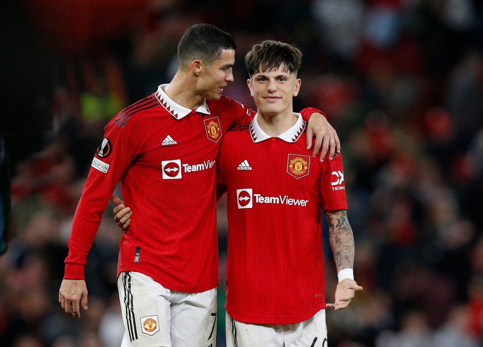 Cristiano Ronaldo and Alejandro Garnacho celebrating after a Manchester United soccer match.