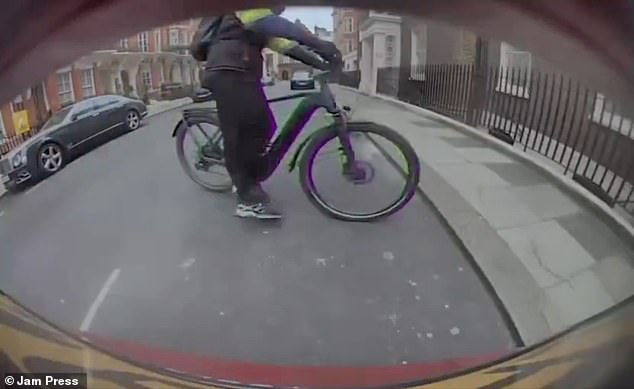 The cyclist was dressed in almost all black and had his face covered, only showing his eyes