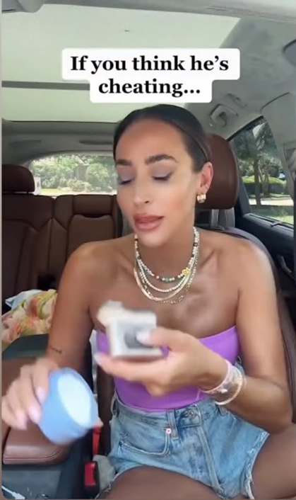 Woman in car holding small box, suggesting infidelity.