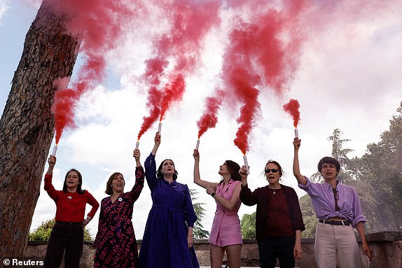 Members of the Catholic women's group, Women's Ordination Conference, hold flares of pink smoke, calling for women's equality in the Catholic church and in protest at male-only conclave, in Rome, Italy, May 7, 2025. REUTERS/Matteo Minnella     TPX IMAGES OF THE DAY