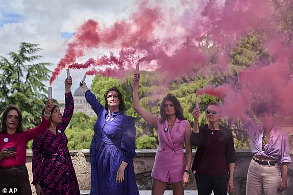 Activists from the Women's Ordination Conference release pink smoke to call for full equality for women in the Catholic Church on the first day of the conclave to elect the 267th pope, in Rome, Wednesday, May 7, 2025. (AP Photo/Bernat Armangue)