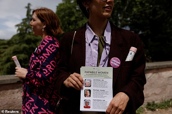 A member of the Catholic women's group, Women's Ordination Conference, holds a papabile women list, calling for women's equality in the Catholic church and in protest at the male-only conclave, in Rome, Italy, May 7, 2025. REUTERS/Matteo Minnella