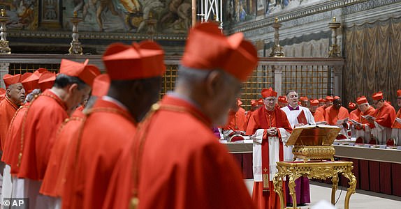 Cardinal Pietro Parolin, center, flanked by assistant Master of Ceremonies Massimiliano Matteo Boiardi, presides over the conclave to elect the successor of late Pope Francis inside the Sistine Chapel at the Vatican, Wednesday, May 7, 2025. (Vatican Media via AP)