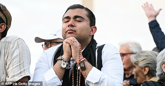 A faithful cries while praying as he waits for the smoke to rise from the chimney on the Sistine Chapel as conclave to elect a new Pope starts, at St Peter's Square in The Vatican, on May 7, 2025. (Photo by Stefano Rellandini / AFP) (Photo by STEFANO RELLANDINI/AFP via Getty Images)