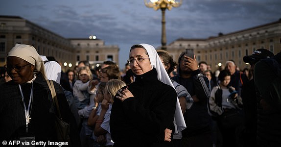 A nun waits for the smoke to rise from the chimney on the Sistine Chapel as conclave to elect a new Pope starts, at St Peter's Square in The Vatican, on May 7, 2025. (Photo by JEFF PACHOUD / AFP) (Photo by JEFF PACHOUD/AFP via Getty Images)