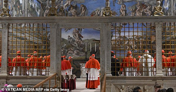 This photo taken and handout on May 7, 2025 by The Vatican Media shows cardinals before the start of the conclave to elect a new Pope in the Sistine chapel in The Vatican. (Photo by Mario Tomassetti / VATICAN MEDIA / AFP) / RESTRICTED TO EDITORIAL USE - MANDATORY CREDIT "AFP PHOTO / VATICAN MEDIA" - NO MARKETING - NO ADVERTISING CAMPAIGNS - DISTRIBUTED AS A SERVICE TO CLIENTS (Photo by MARIO TOMASSETTI/VATICAN MEDIA/AFP via Getty Images)