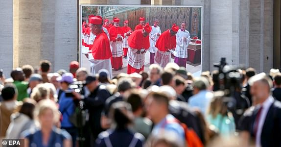 epa12081035 A giant screen installed in St. Peter's Square shows the cardinal electors as the conclave to elect a new pope starts, in the Vatican, 07 May 2025.  EPA/ANDREA SOLERO