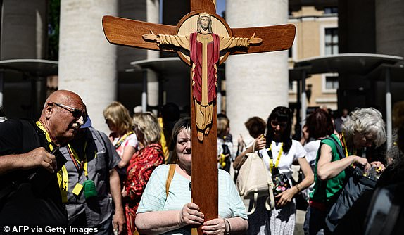 Faithful enter St Peter's Square ahead of the conclave to elect the next pope at the Vatican, in The Vatican, on May 7, 2025. (Photo by JEFF PACHOUD / AFP) (Photo by JEFF PACHOUD/AFP via Getty Images)