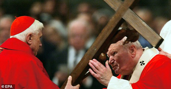 epa12036879 (FILE) Pope John Paul II (R) kissing the wooden crucifix held by Cardinal Joseph Ratzinger (L), during the Good Friday Passion Mass, in St. Peter's Basilica, at the Vatican, 09 April 2004 (reissued 17 April 2025). On 19 April 2005, Joseph Ratzinger became Pope Benedict XVI, succeeding John Paul II. Known as the â¿¿Professor Pope,' his papacy emphasized doctrinal clarity and tradition. He simplified some papal ceremonies, favored pastoral visits over major events, and resigned in February 2013, making way for Pope Francis.  EPA/MAURIZIO BRAMBATTI ATTENDION EDITORS: THE PICTURE IS PART OF A WIDER COLLECTION ON POPE BENEDDICT XVI AVAILABLE AT EPAIMAGES.COM