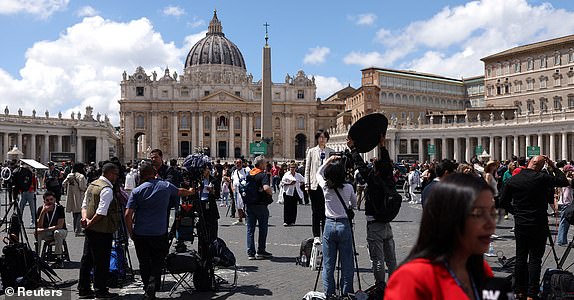 Media members gather near the St. Peter's Basilica, on the first day of the conclave to elect the next pope at the Vatican, as seen from Rome, Italy, May 7, 2025. REUTERS/Amanda Perobelli