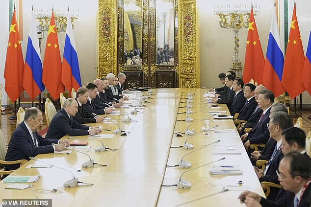 Russian President Vladimir Putin and Chinese President Xi Jinping speak during a meeting at the Kremlin in Moscow, Russia, May 8, 2025