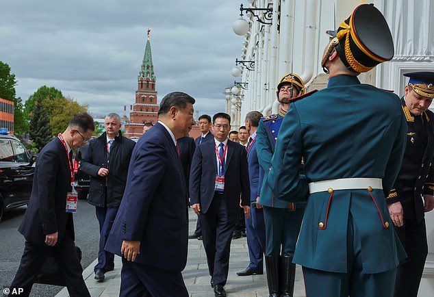 Russian President Vladimir Putin, second left, talks during meeting with Chinese President Xi Jinping, center right, at the Kremlin in Moscow, Russia, Thursday, May 8, 2025