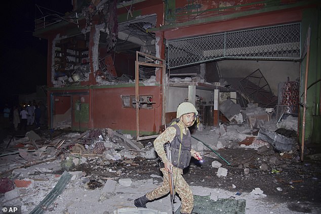 An army soldier examines a building damaged by a suspected Indian missile attack near Muzaffarabad, the capital of Pakistan controlled Kashmir, in Wednesday, May 7, 2025
