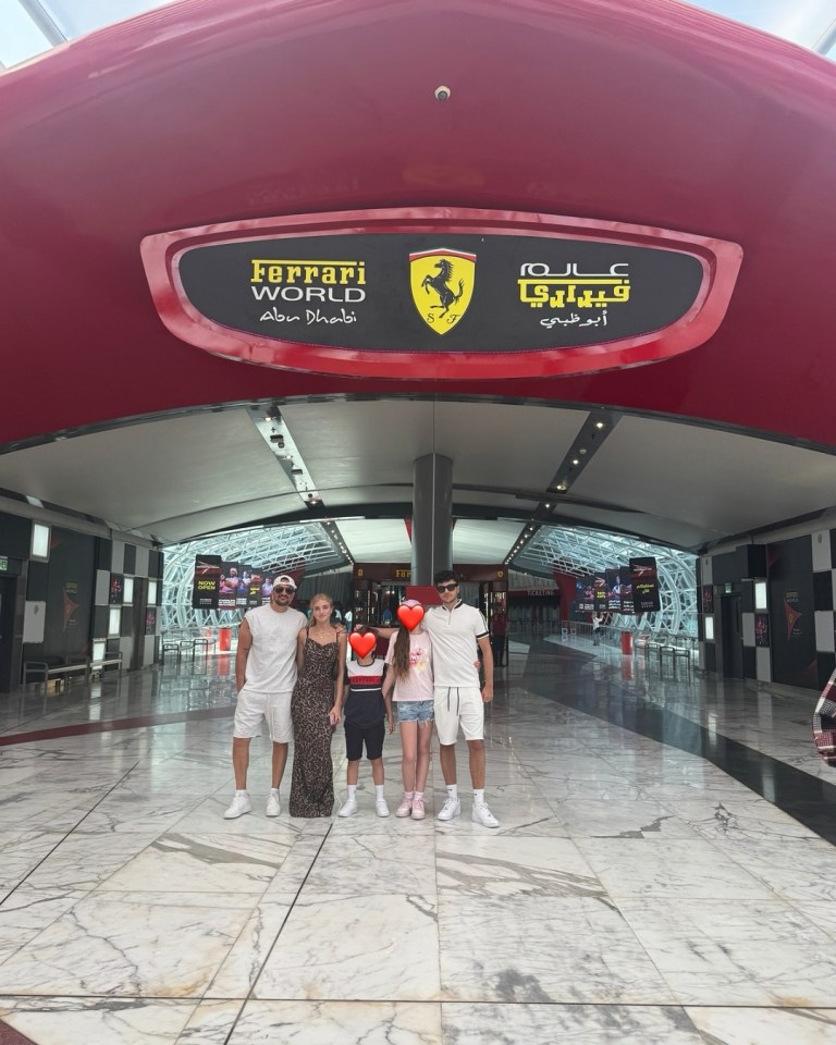 Family posing at the entrance to Ferrari World Abu Dhabi.