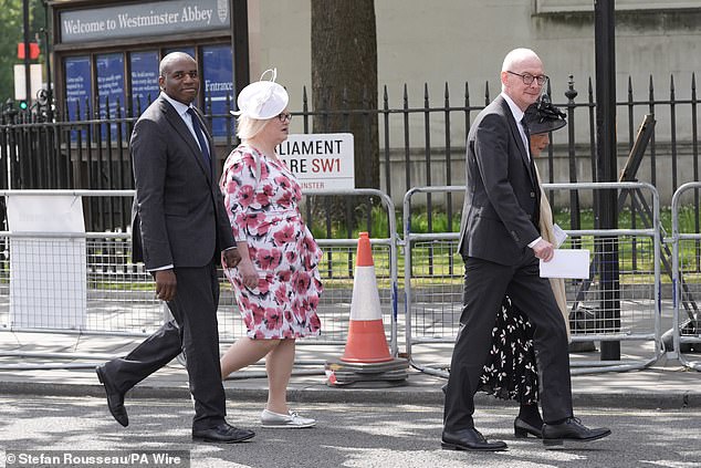 Foreign Secretary David Lammy (left) walks in procession from the Palace of Westminster