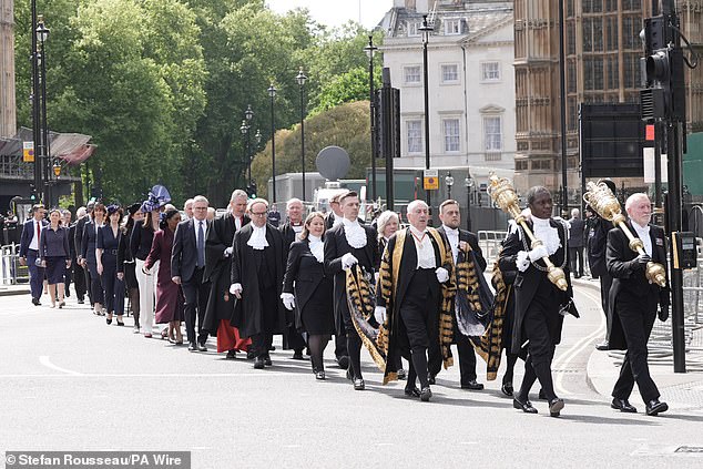 MPs and peers walk in procession from the Palace of Westminster to Westminster Abbey today