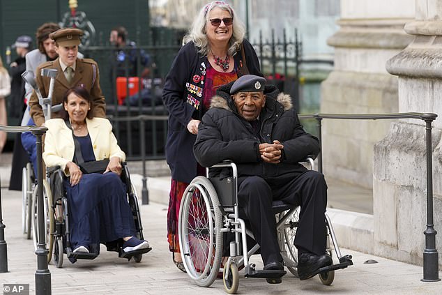 Veteran Gilbert Clarke (right) arrives at Westminster Abbey for today's service of thanksgiving