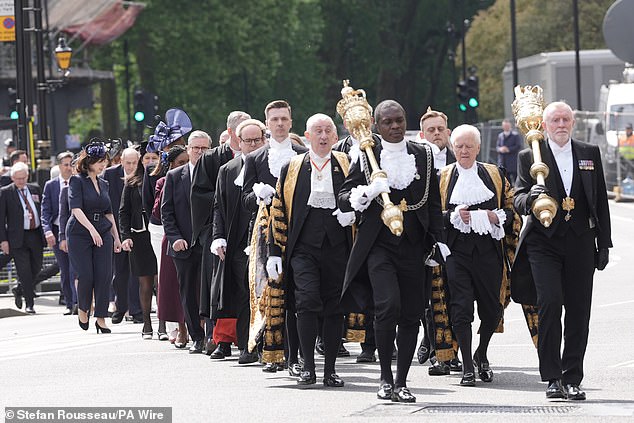 MPs and peers walk in procession from the Palace of Westminster to Westminster Abbey today