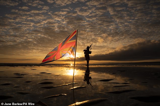 Scotland's National Piper Louise Marshall playing a lament to the fallen at dawn on Portobello Beach in Edinburgh today, overlooking the Firth of Forth on the 80th anniversary of VE Day