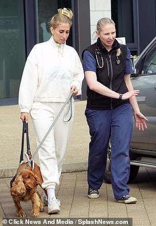 The star listened to the vet as they walked towards her parked car