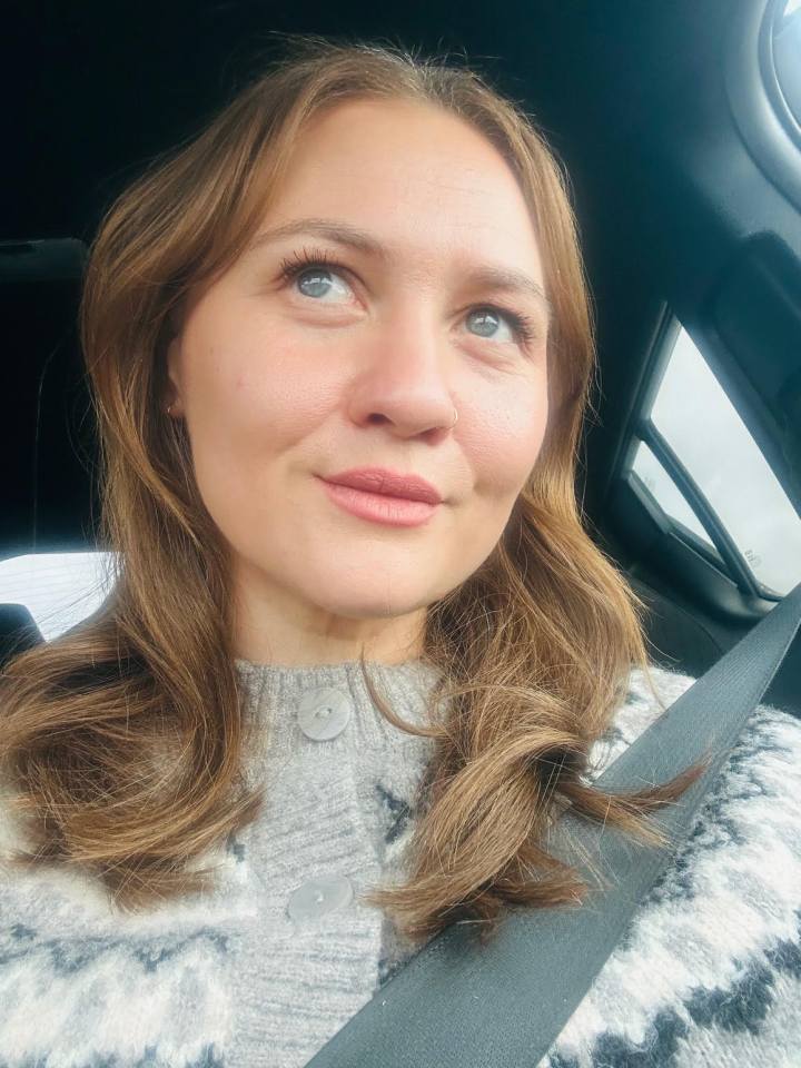 Woman looking out a car window.