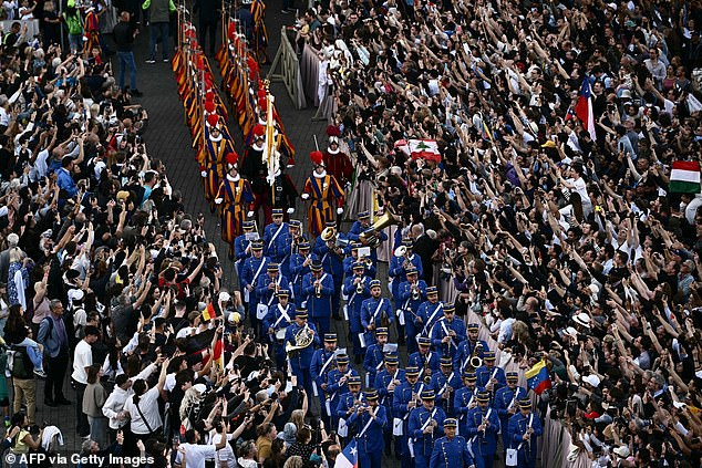 Swiss Guards and music band enter the parvis of St Peter's basilica before the first appearance of the new Pope, after the cardinals ended the conclave