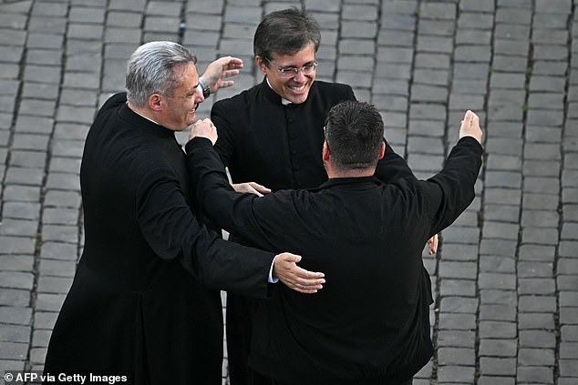 Prelates celebrate on St Peter's Square as cardinals signaled they elected a new pope during their conclave