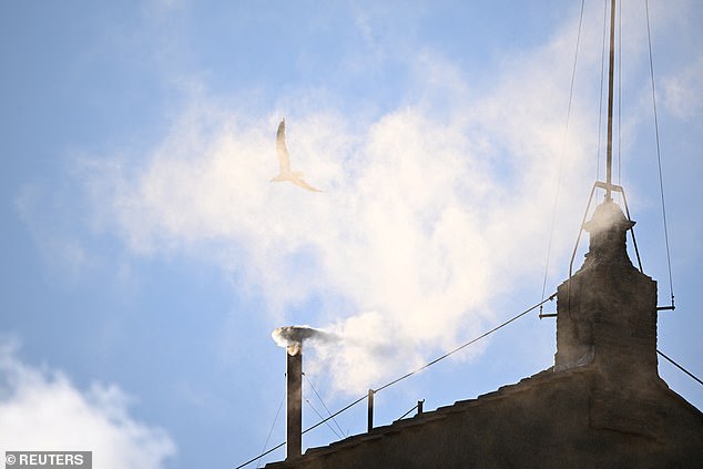 White smoke rises from the chimney on the Sistine Chapel, indicating that a new pope has been elected at the Vatican