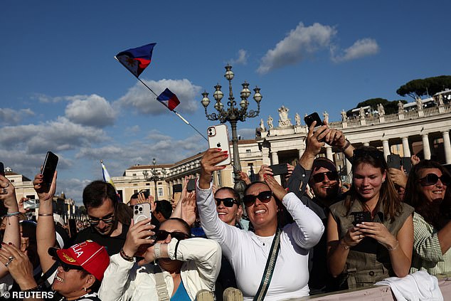 Faithful react to the white smoke