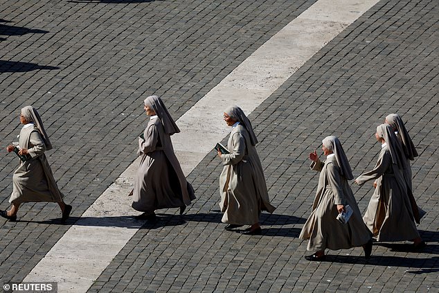 Nuns walk near Saint Peter's Basilica, on the second day of the conclave to elect the new pope