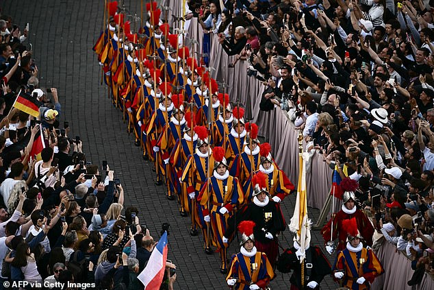 Swiss Guards take position on the parvis of St Peter's basilica before the first appearance of the new Pope