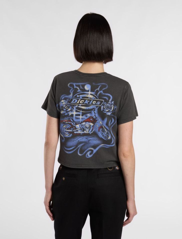 Woman's back, wearing a dark gray cropped t-shirt with a motorcycle graphic and Dickies logo.