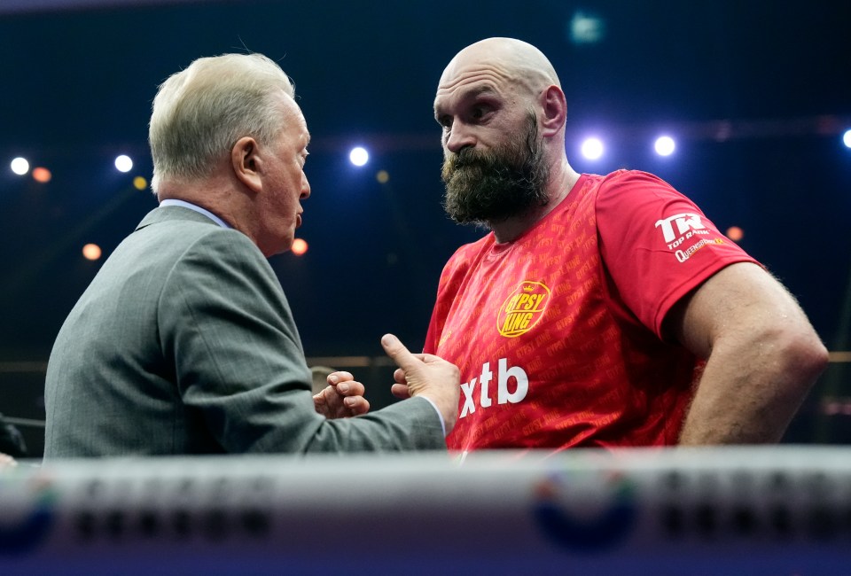 Tyson Fury and Frank Warren talking after a boxing match.