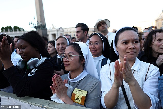 Nuns pray in the crowd following the announcement that Cardinal Robert Prevost has been elected by the conclave as the new pope