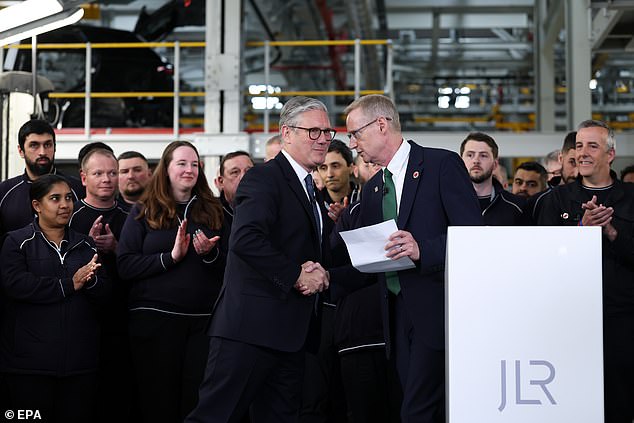 JLR CEO Adrian Mardell shaking hands with Prime Minister Keir Starmer today at the car maker's Halewood plant in the West Midlands. Mardell said: 'We warmly welcome this deal which secures greater certainty for our sector and the communities it supports'