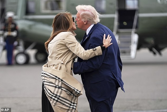 First lady Melania Trump (left) splits off from her husband President Donald Trump (right) on the tarmac at Newark Liberty International Airport in New Jersey after their trip to Rome