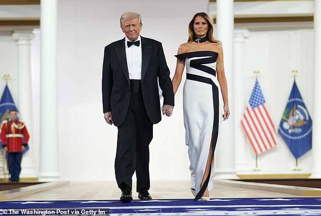 President Donald Trump (left) and first lady Melania Trump (right) arrive hand-in-hand to the Commander-in-Chief inaugural ball on inauguration day in January