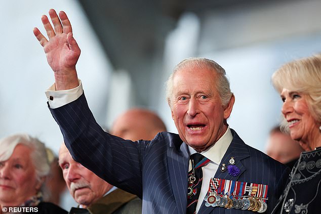 The King - who made a moving speech at the event - was pictured waving at crowds from the Royal Box