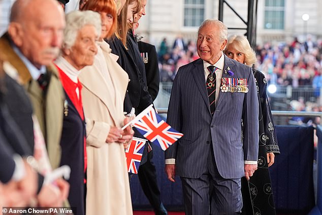 Charles, looking dapper in a pin-stripe suit, was in high spirits as he and his wife made their arrival