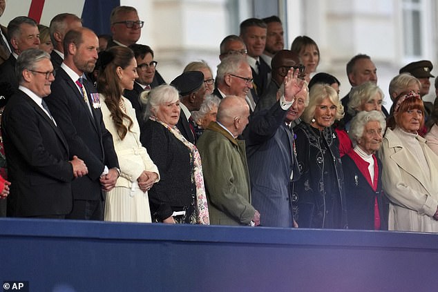 King Charles III pictured waving during the live celebratory concert to conclude the national V-E Day