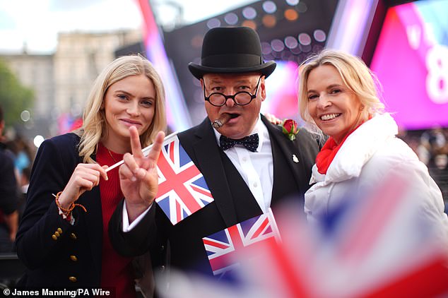 People posing for a photo with a Winston Churchill lookalike at the concert celebrating the 80th Anniversary of VE Day