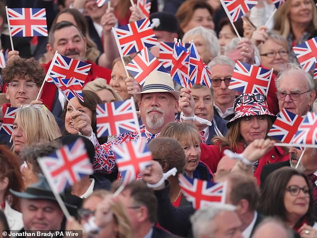 Members of the audience pictured waving their Union flags during the concert celebrating the 80th Anniversary of VE Day