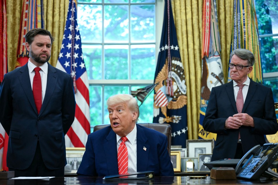 President Trump announcing a trade agreement with Britain, flanked by aides.