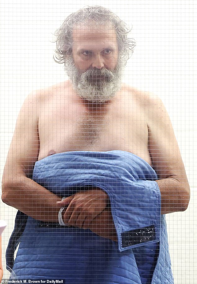 Carwyle, 48, shot cameras chilling glares and smiles as he appeared behind glass in a custody area of a Los Angeles courtroom Thursday