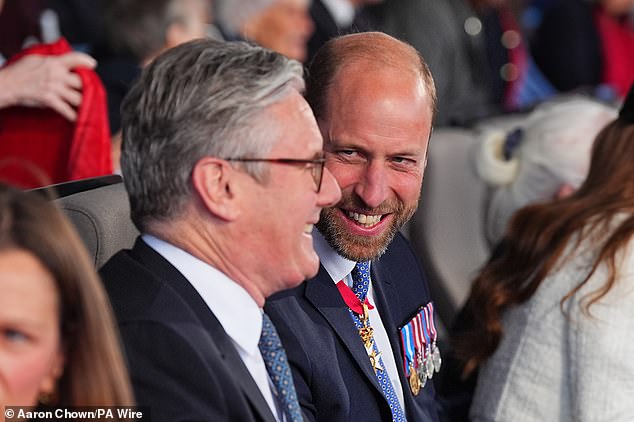 William (pictured) chuckled as he chatted with Sir Keir, the Prime Minister, who he sat next to this evening
