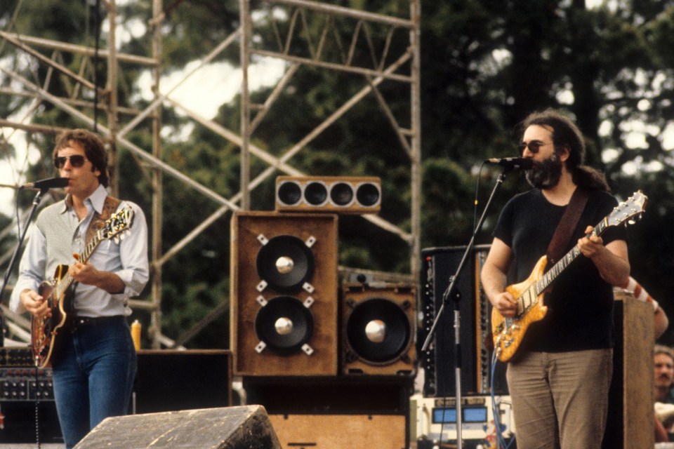 Bob Weir and Jerry Garcia of the Grateful Dead performing on stage.