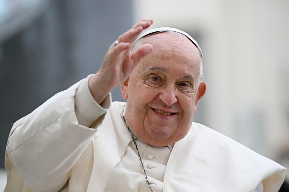 Pope Francis waves to a crowd.