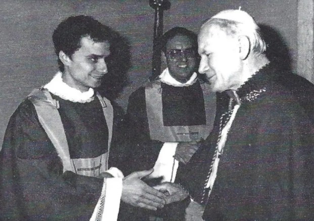 Black and white photo of Pope John Paul II shaking hands with newly ordained Rev. Robert Francis Prevost.