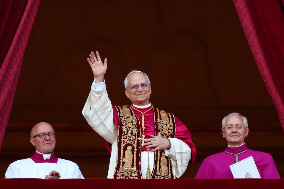 Newly elected Pope Leo XIV waving from a balcony.